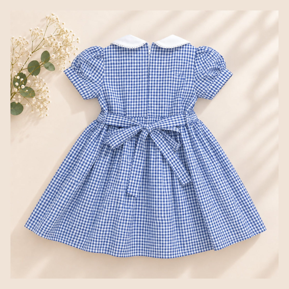 Blue gingham girls dress with white collar and waist bow - back view