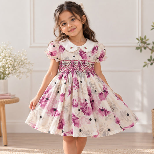 Front view of purple floral hand-smocked 100% cotton girls dress with Peter Pan collar and lace trim